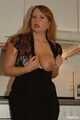 Chubby redhead  Benita stripping out of her black dress in the kitchen