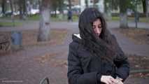 Raven-haired smoker takes a drag on a cork cigarette of her favorite brand