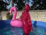 Watch Sandra watering the garden and wetting her shiny nylon oldschool Rainsuit in the Pool