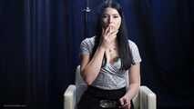 Brunette with mysterious look smoking all white cigarette