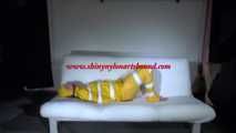 Watching Pia wearing a sexy yellow rainwear being tied and gagged with tape and a ballgag on a sofa (Video)