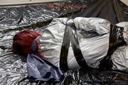 Mara tied and gagged with tape on bed wearing s shiny silver PVC sauna suit (Pics)