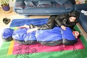 An archive girl tied and gagged in a sleepingsack by Jill on the floor both wearing shiny down jackets (Pics)