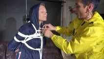 Sandra tied and gagged overhead with ropes and a ballgag overhead prepared to be hunged up by Stella both wearing sexy shiny nylon rainwear (Video) 