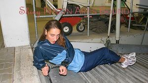 Stella tied and gagged in a garage wearing a shiny rainwear combination (Pics)