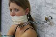 Heavy cuffed and gagged to the wall