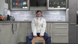 Miss Amira in Farmerrain raingear bound and gagged on a chair