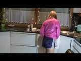 Watching our sexy archive girl wearing a sexy blue shiny nylon shorts and a pink rainjacket doing her housework (Video)