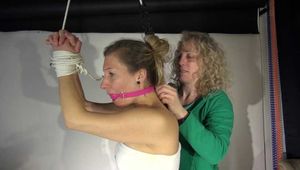 Watching sexy Sandra being tied and gagged with ropes and a ballgag overhead wearing shiny nylon shorts and a top (Video)