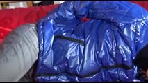 Sonja tied and gagged with cuffs and a gag on bed wearing a sexy grey shiny nylon rain pants and a blue down jacket (Video)