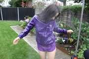 Watching sexy Aiyana wearing a sexy purple shiny nylon shorts and a purple shiny nylon rain jacket enjoying the garden shower (Pics)