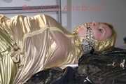 Pia tied, gagged and hooded on bed wearing a sexy golden rain combination and wings (Pics)