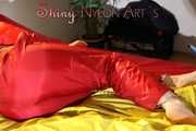 Watching sexy Jill wearing a red shiny nylon rain pants and an oldschool rain jacket under a red downjacket being tied and gagged with ropes and a ballgag on a bed (Pics)