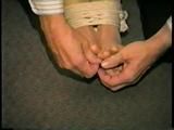 30 YR OLD ASIAN LI-JUN IS WRAP TAPE GAGGED, BALL-TIED, TOE-TIED IN PANTYHOSE (D55-11)