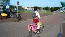 I’m cycling through Amsterdam in my mini school uniform