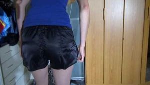 Sexy Sojna wearing a jeans and a tshirt trying on several shiny nylon shorts and posing (Video)