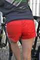 Watch Sandra riding her bike enjoying her red shiny nylon Shorts