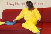 Jill ties, gagges and hoodes herself wearing a shiny yellow down jacket and a yellow rain pants(Pics)