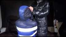 Watching SEXY MARA sitting on a chair being tied and gagged with tape and a clothgag and hood her the other way round (Video)
