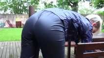 Watching sexy Courtney feeling comfortable in her dark blue  shiny nylon rainwear cleaning the table outside (Video)