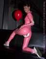 A babypink latex catsuit with Emma and a wet diaper inside