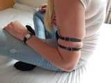 Tight little leather straps around Janes soft upper arms