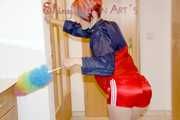 SONJA wearing a sexy red shiny nylon shorts and a red/blue rain jacket cleaning up the flat (Pics)