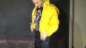 Sexy Mara trying on her new yellow down jacket and her lifevest in combination with a sexy shiny black rain pants and rubber boots (Video)