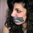 35 YEAR OLD ITALIAN HAIRDRESSER IS DUCT TAPE GAGGED, HANDGAGGED, ROPE TIED, BLINDFOLDED & WEARING A GARTER BELT AND NYLON STOCKINGS (D68-9)