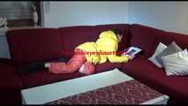 Watching sexy Lucy wearing a orange/yellow shiny nylon downwear combination reaing a magazine and lolling on the sofa (Video)