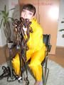 Jill tied, gagged and hooded with a tension belt on a chair wearing a supersexy yellow shiny nylon rainpants and rain jacket (Pics)