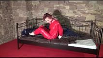 Mara tied and gagged on a princess bed in an old cellar wearing a sexy red sauna suit (Video)