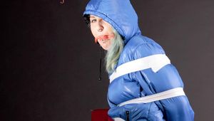 Mara tied, gagged and hooded with tape and a ball gag on a bar stool in a studio wearing a sexy oldschool lightblue downwear skibib (Pics)