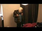 Blonde-haired archive girl going out wearing shiny nylon rainwear (Video)