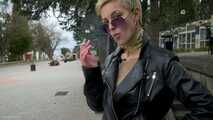 Short cut hair blonde girl is smoking two cork cigarettes