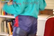 Mara wearing a sexy shiny nylon shorts over a rain pants and a rain jacket during her workout infront of the TV (Pics)