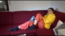 Watching sexy Lucy wearing a orange/yellow shiny nylon downwear combination reaing a magazine and lolling on the sofa (Video)