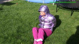 Watch Sandra beeing bound and gagged in her shiny nylon Downwear in the Garden