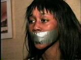 BLACK FEISTY & CUTE SARAH IS TAPE GAGGED, MOUTH STUFFED, TIED WITH RAWHIDE & TIGHTLY HANDGAGGED (D53-16)
