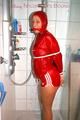 Stella tied and gagged under the shower wearing a shiny red nylon shorts and rain jacket (Pics)