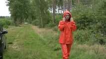 Miss Petra takes a walk in a orange AGU rain suit and rubber boots