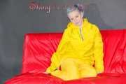 MARA wearing a sexy yellow shiny nylon rain suit lolling and posing on a bed (Pics)