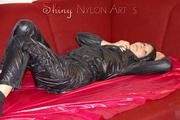Lucy wearing a very hot black rainwear combination lolling and posing on a sofa (Pics)