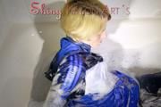 Watching Sonja taking a foam bath  wearing sexy blue shiny nylon rainwear (Pics)