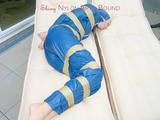 Beautiful archive girl in a blue shiny nylon rainsuit tied and gagged with tape on a sunlounger (Pics)