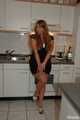 Chubby redhead  Benita stripping out of her black dress in the kitchen