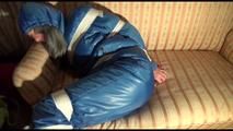 Mara tied, gagged and hooded on a sofa wearing a sexy blue shiny nylon down skibib (Video)