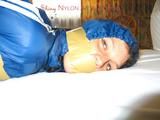 One of our archive girls bound and gagged in a blue shiny rainsuit 