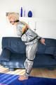 Blond-haired maid tied and gagged with tape wearing a shiny silver PVC sauna suit (Pics)