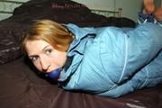 Katharina tied and gagged in a blue skisuit